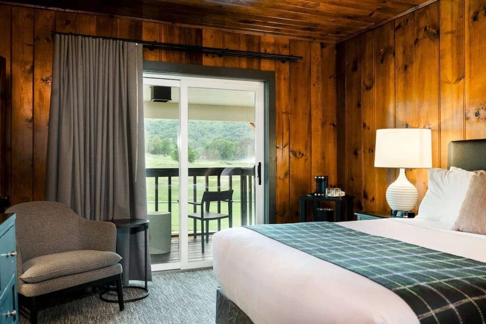 Cozy bedroom with chair and sliding door to balcony