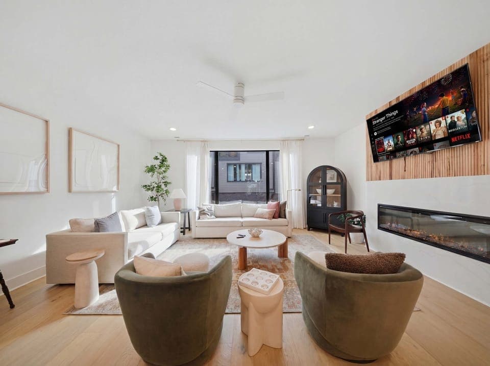 Living Room: Experience sophisticated living. From the sleek fireplace feature to the inviting sofa and fully-equipped kitchen, every detail in this space is curated for your ultimate comfort and enjoyment.