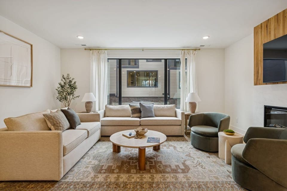 Living Room: Experience sophisticated living. From the sleek fireplace feature to the inviting sofa and fully-equipped kitchen, every detail in this space is curated for your ultimate comfort and enjoyment.