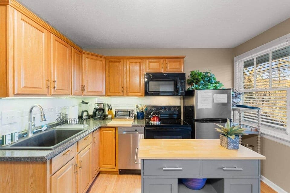 Spacious kitchen with all utilities including dishwasher, stove and refrigerator.