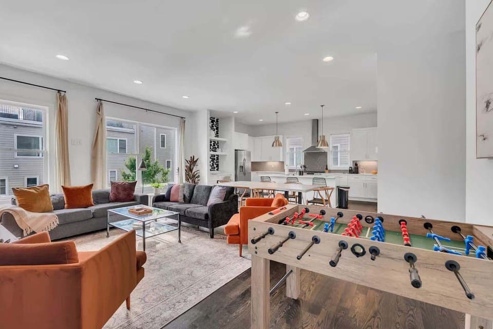 Open-concept living room with plush seating, large windows, and a chef's kitchen. | Unit A







Sunlit open-concept living with plush seating, large windows, Foosball and a chef's kitchen. | Unit A
