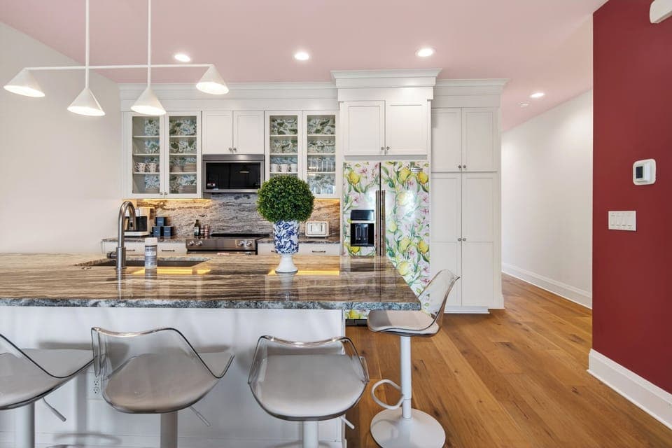 Bright kitchen with island seating and modern appliances.