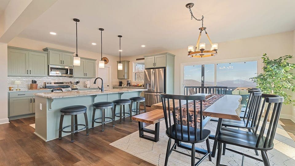 Fully stocked kitchen with counter seating and a large table. 