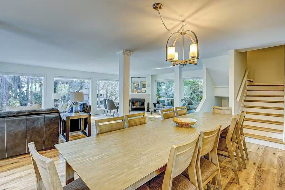 Gather around this beautiful wooden dining table where memorable meals and conversations await in your bright, open-concept retreat.