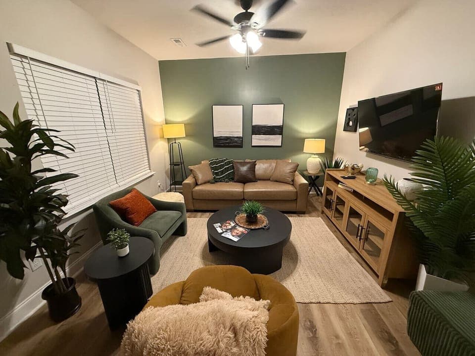 The living room offers ample seating, a 55” Smart TV, and a quiet environment ideal for relaxing after exploring the area.
