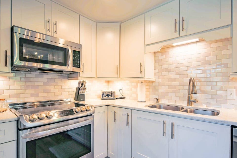 The kitchen has an electric range, microwave, toaster and dishwasher.