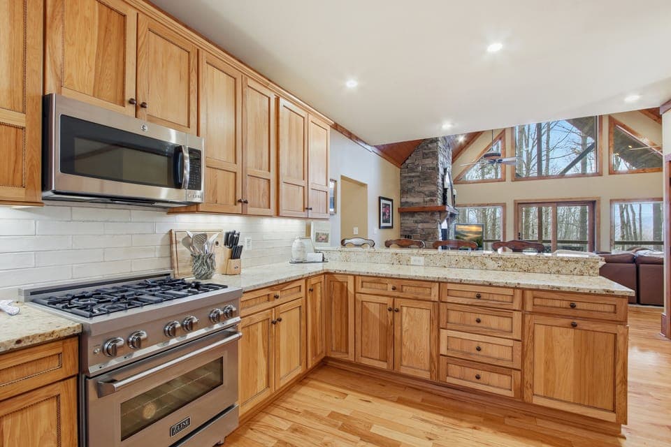 Open kitchen flows into the great room with stone fireplace