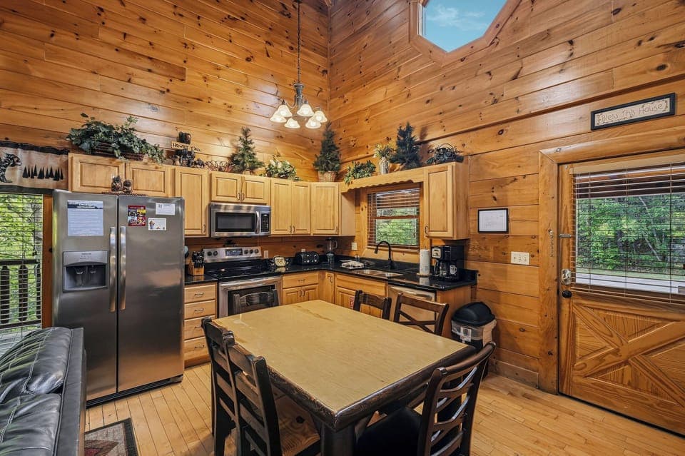 Gather around your spacious kitchen's dining table where rustic charm meets modern convenience, surrounded by warm wood and natural light.