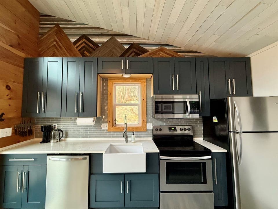 Full-size stainless appliances, soft-close cabinets, and everything you need to cook comfortably- small space, big function.