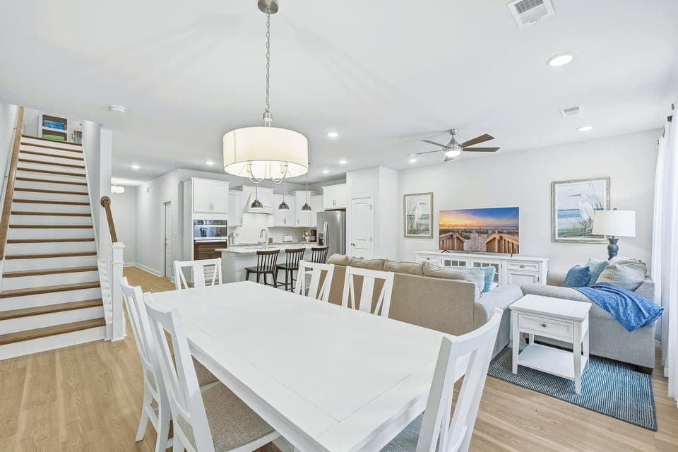 Dining table has seating for six and three barstools at the breakfast bar. 