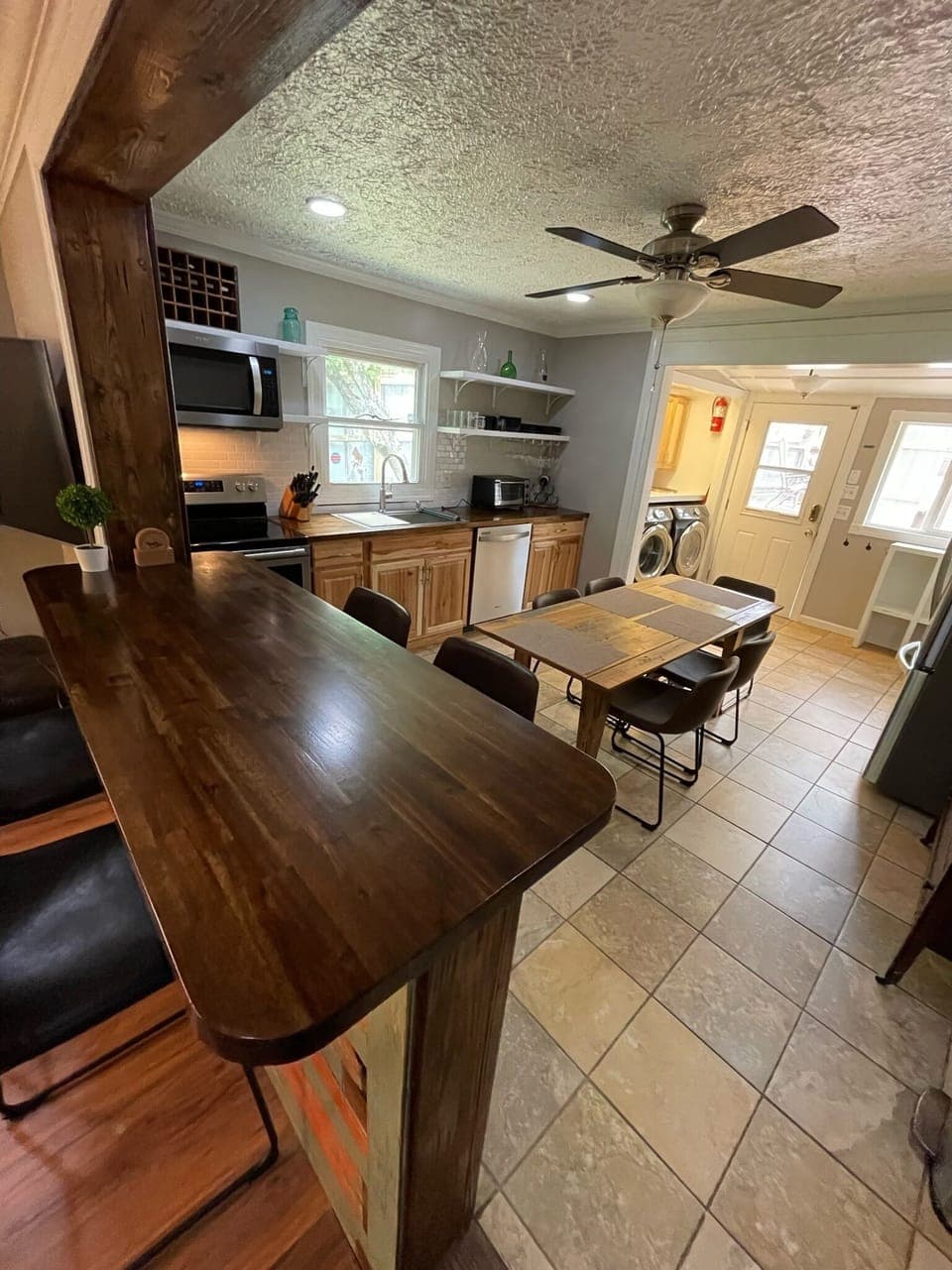 Open kitchen and dining with bar seating in Brevard NC furnished home
