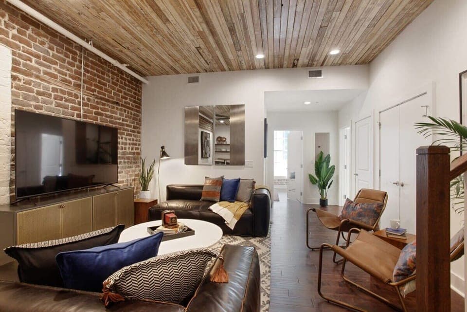 Unit A Living Room | Comfortable Seating Area and TV | First Floor of Third Floor Unit