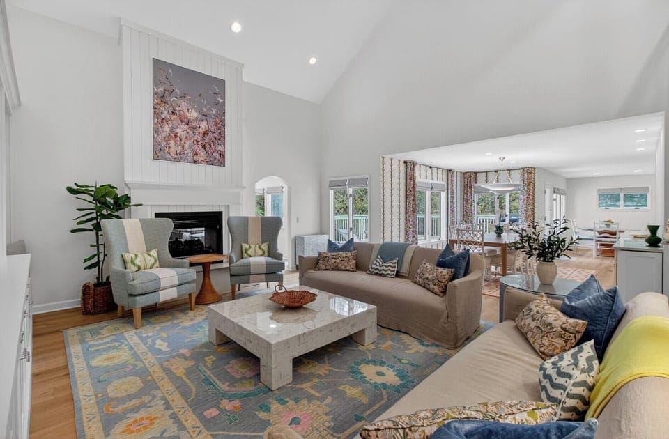 Unwind in your spacious living room with vaulted ceilings, cozy fireplace, and stylish furnishings that create the perfect atmosphere for relaxation.