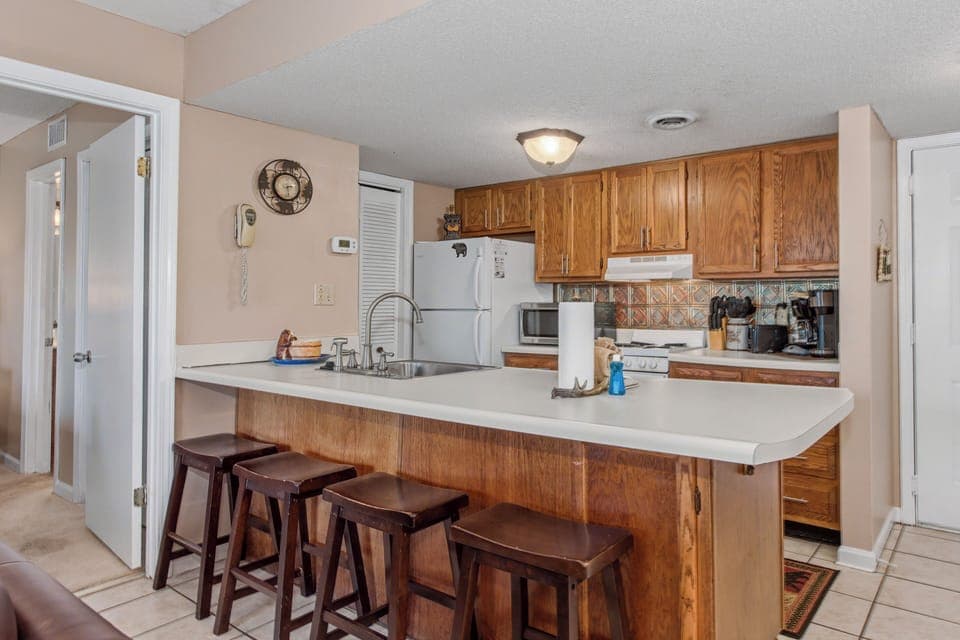 Your fully equipped kitchen with breakfast bar seating invites you to prepare meals and gather with loved ones in this warm, welcoming space.