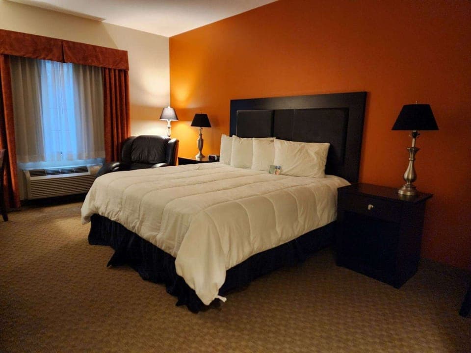 Premium bedding, desk, laptop workspace, blackout drapes