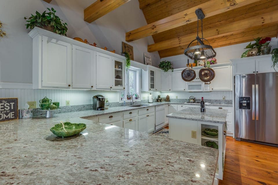 The open kitchen has loads of granite counter space.