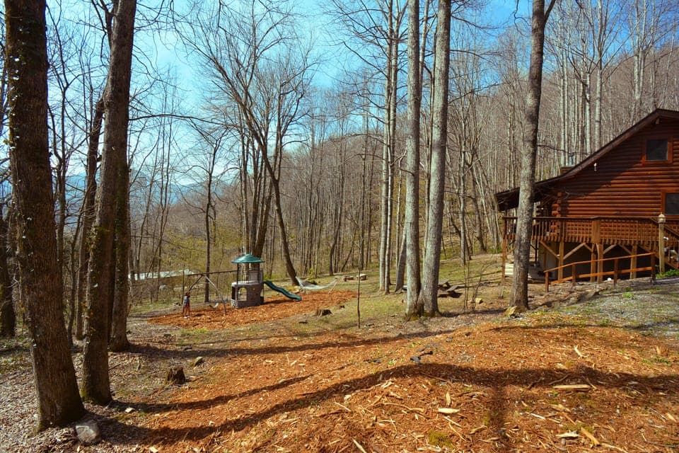 huge private backyard with playground, hammock, firepit, tetherball, and grills