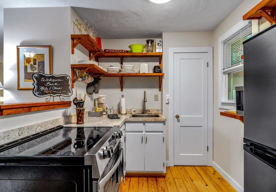 Fully stocked kitchen features a new stove/oven and refrigerator and deep sink