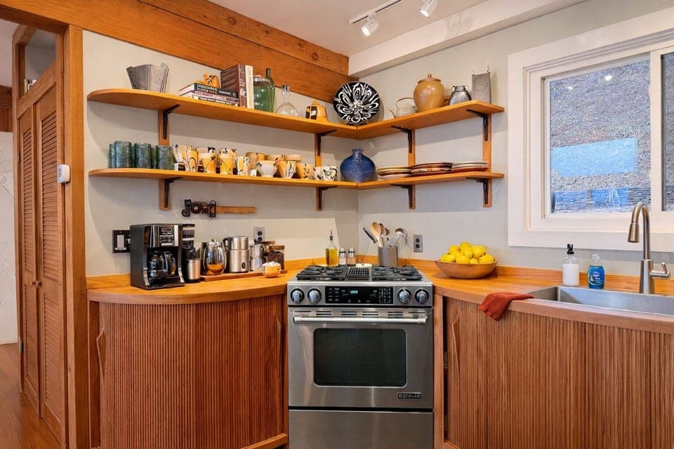 Dual fuel stove with downdraft and convection oven make cooking for friends easy
