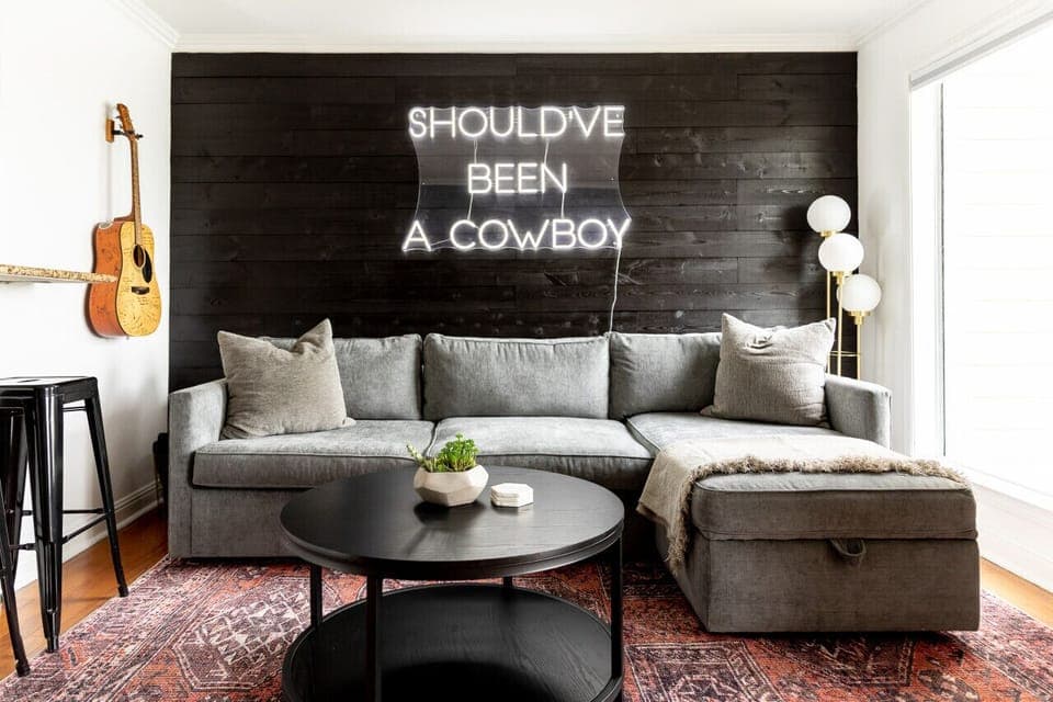 Comfortable living room with attached private patio that overlooks the Cumberland River. The couch turns into a Queen sleeper sofa. Smart TV with cable and all the apps you could want. Custom Neon Sign as well!