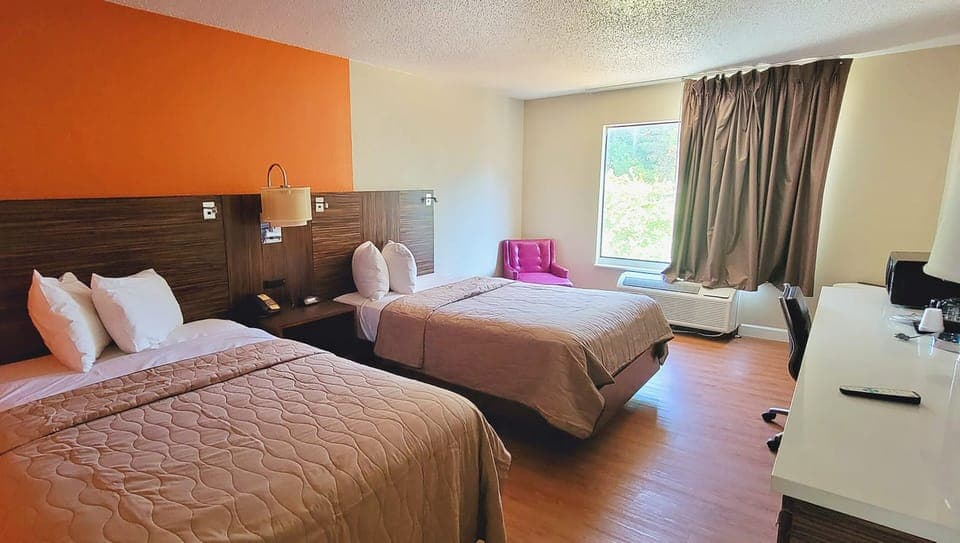 Hypo-allergenic bedding, desk, laptop workspace, blackout drapes