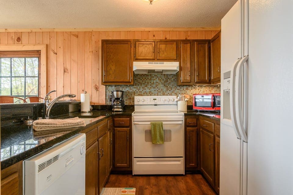 Kitchen on Main Level looks over Bar into Dining Area