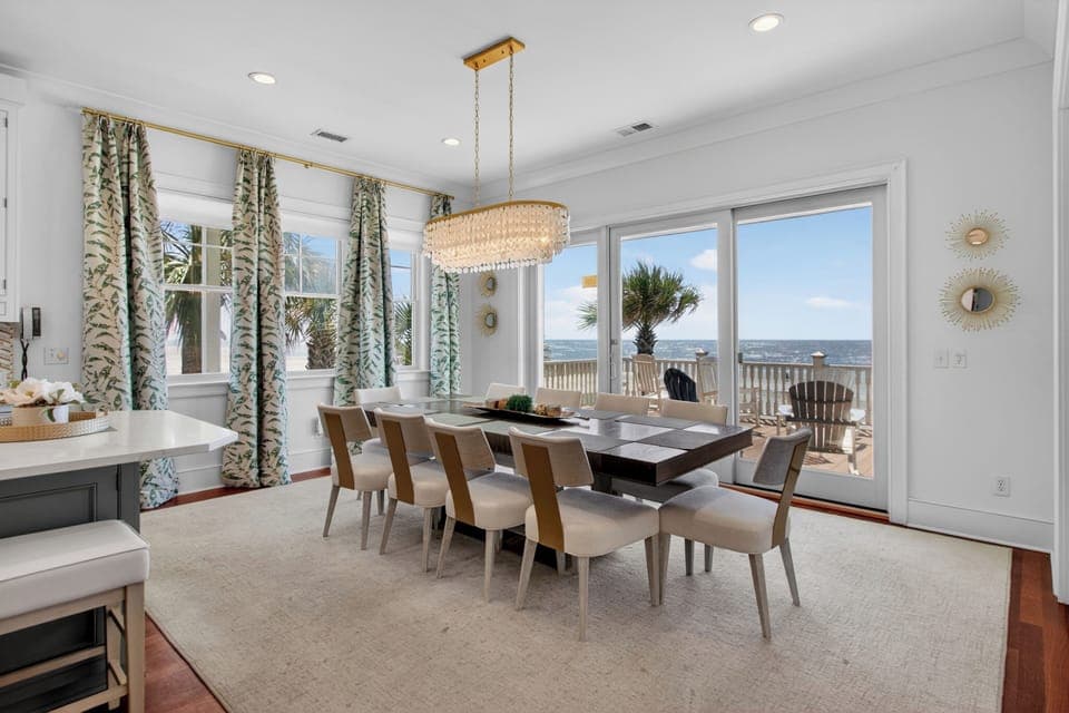 Your stunning dining room showcases ocean views through expansive windows, creating the perfect backdrop for memorable meals with family and friends.