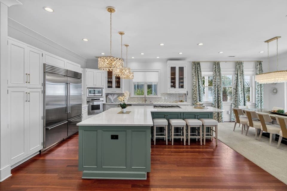 Your dream kitchen awaits with marble countertops, statement island, and warm wood floors perfect for memorable meals.