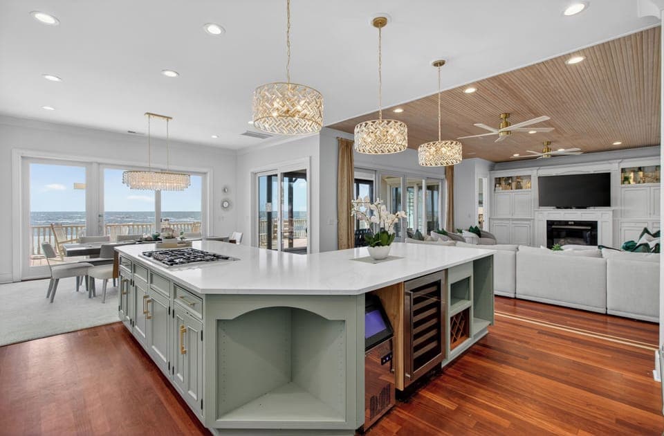 Gather around your spacious kitchen island where gorgeous pendant lights illuminate cooking adventures and ocean breezes drift through open doors.