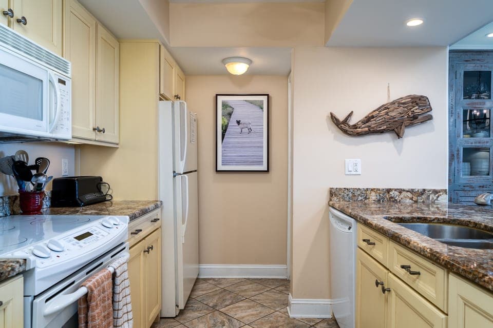 The galley kitchen opens to the great room.