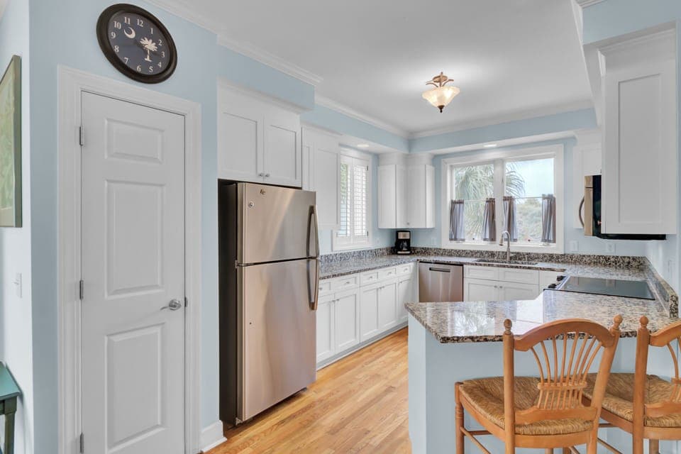 Your fully equipped kitchen features granite counters, stainless appliances, and warm hardwood floors—perfect for preparing meals during your stay.