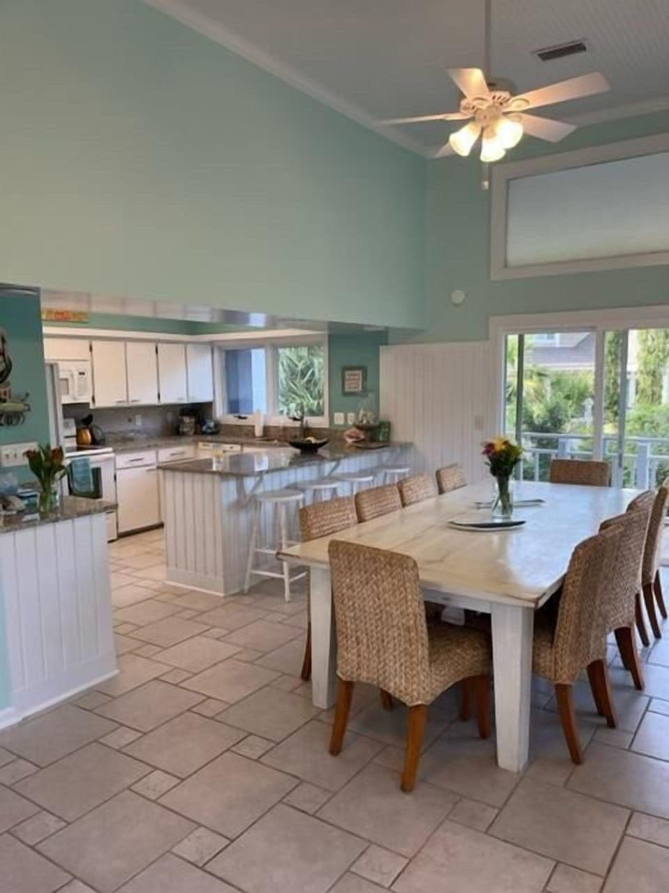 The large table seats 10 and offers views to the lush landscape outside.