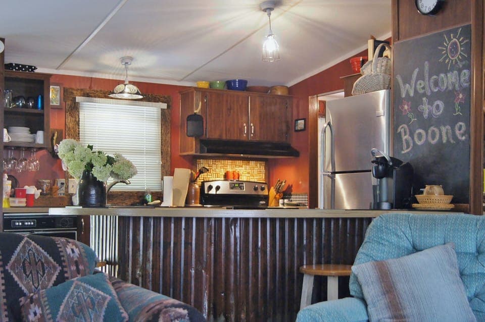 View toward kitchen with amenities like wine glass rack, cork thingy and sink!