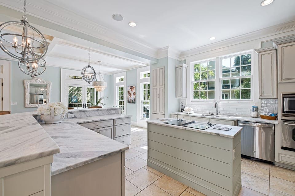 Newly remodeled kitchen with a view out the window to the pool deck spa area