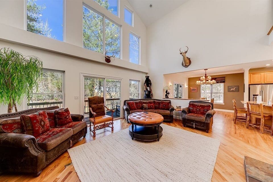 Beautifully furnished open concept living area with a wall of widows