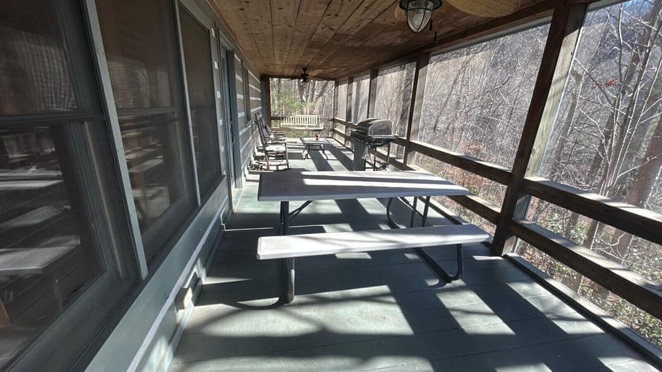 screened porch with grill and picnic table