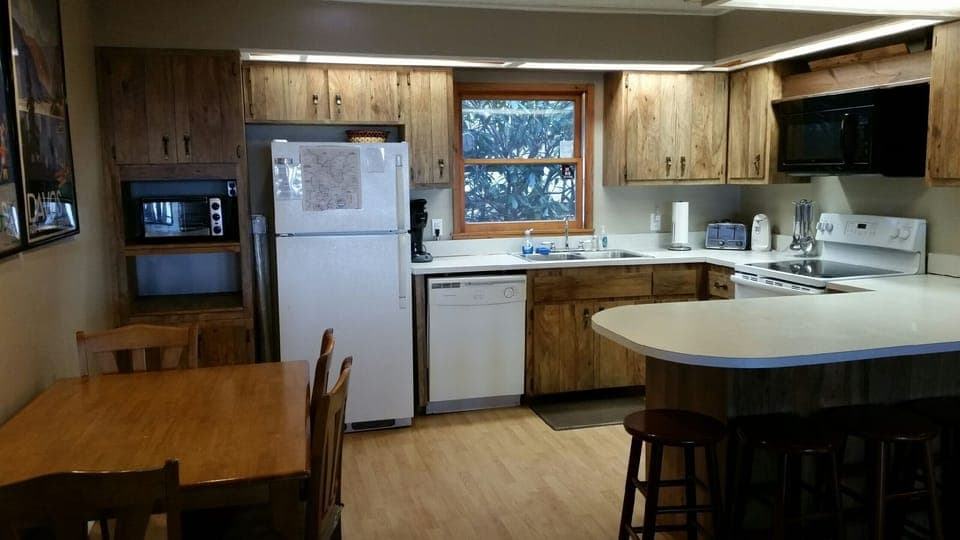 full kitchen, seats ten, there are 4 chairs with table, and 6 stools at counter