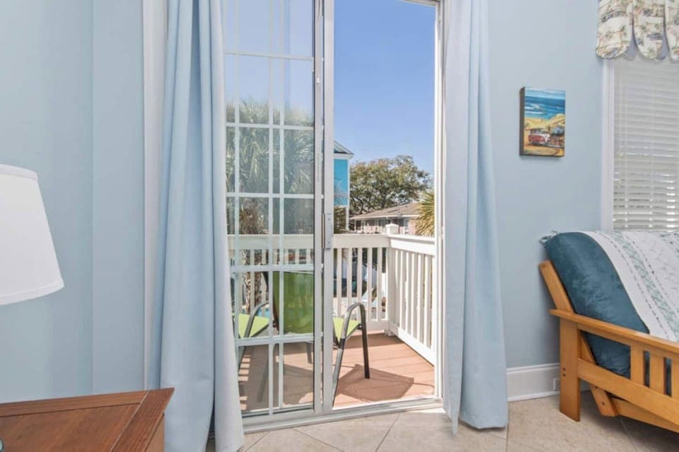 Private views, poolside perks! This main-floor bedroom offers direct access to its own balcony overlooking the pool—perfect for starting your day with a breeze and ending it with a sunset.