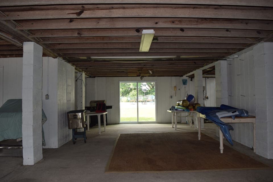 Under house space leading to backyard in-ground pool
