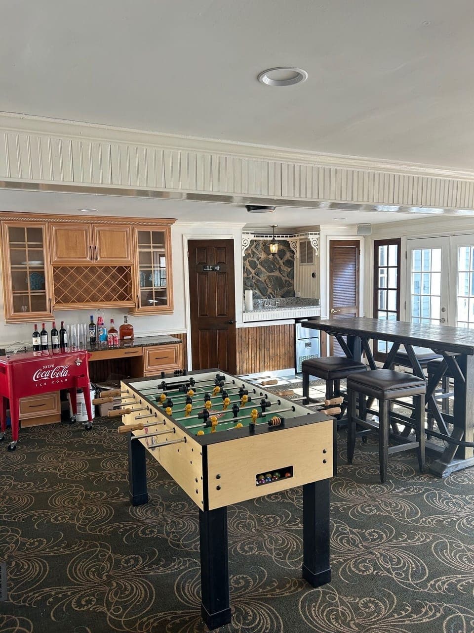 Entertainment room with dry bar, wet bar and foosball