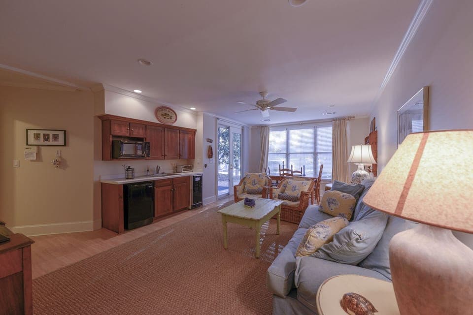 Another view of lower level den w mini kitchen  w dining table overlooks lake