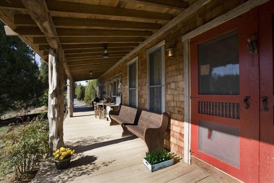 The front porch overlooks sunny gardens and woods, not another soul in sight!