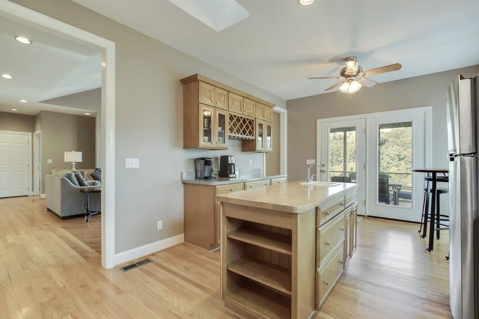 Spacious Gourmet Kitchen with Island.   Doors open to Screened In Porch