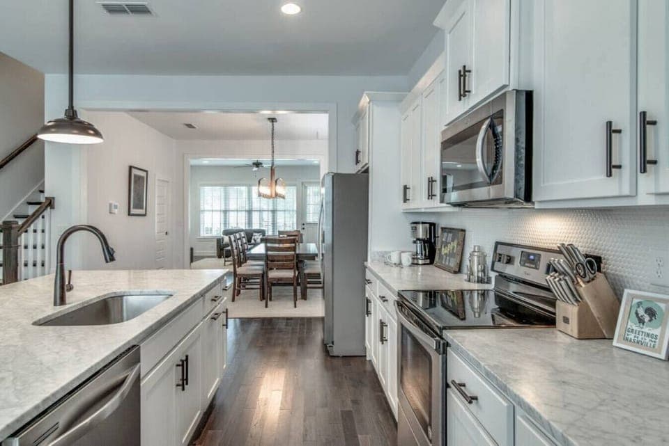 Kitchen fully stocked with all cooking essentials, oven, dishwasher, microwave, stove and drop coffee maker