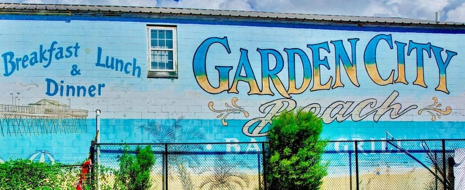 Colorful Garden City Beach mural welcomes visitors with coastal charm and local dining options nearby.