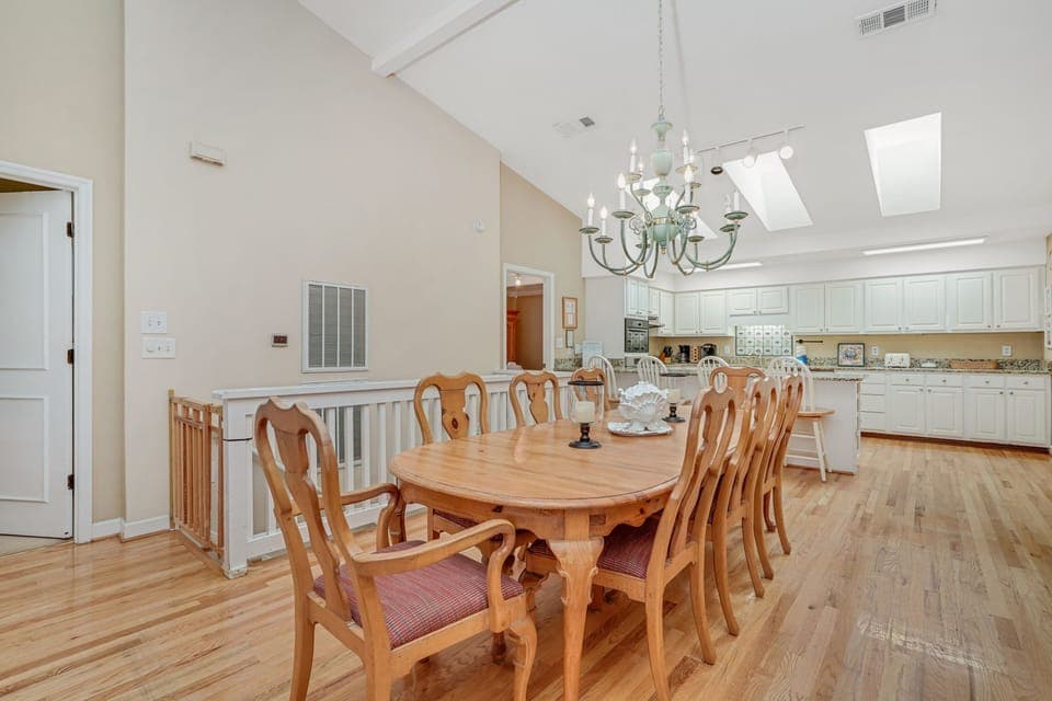 Gather around your elegant dining table for memorable meals beneath soaring vaulted ceilings and natural skylight illumination.