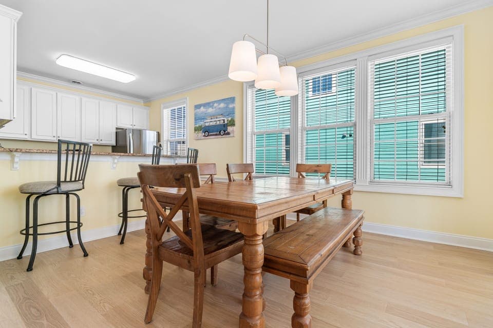 Gather around your beautiful wooden dining table for memorable meals in this bright, open kitchen-dining space.