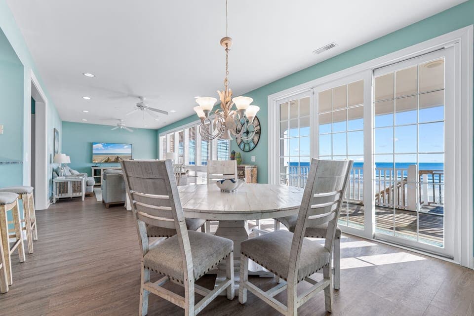 Your beachfront dining area opens to stunning ocean views through floor-to-ceiling windows, creating the perfect setting for memorable meals.