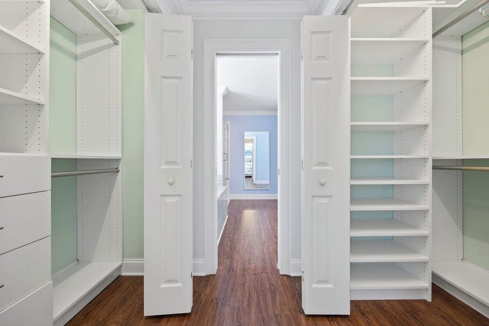 Your spacious walk-in closet features custom shelving and drawers, giving you plenty of room to organize your wardrobe in style.