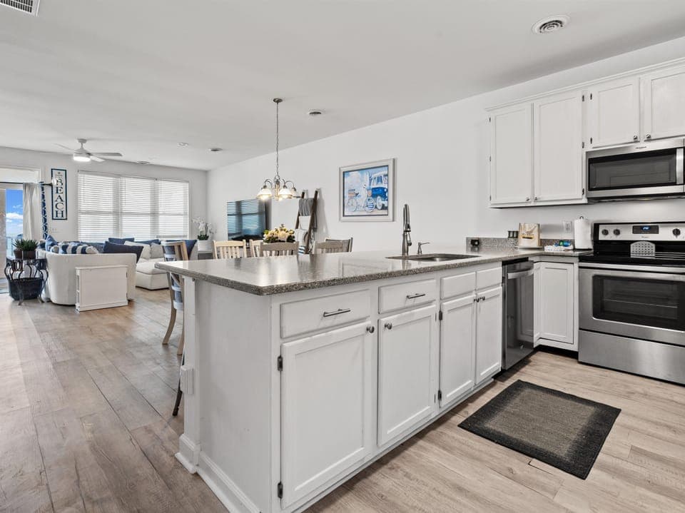 Your spacious open-concept kitchen flows seamlessly into the living area, perfect for cooking and entertaining together.